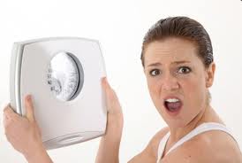 woman angry with weight scale results